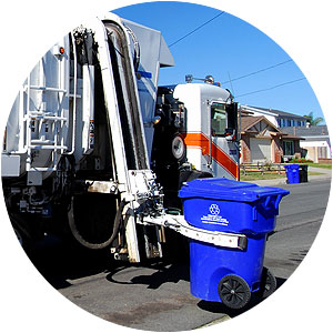 Garbage truck picking up recycling bin